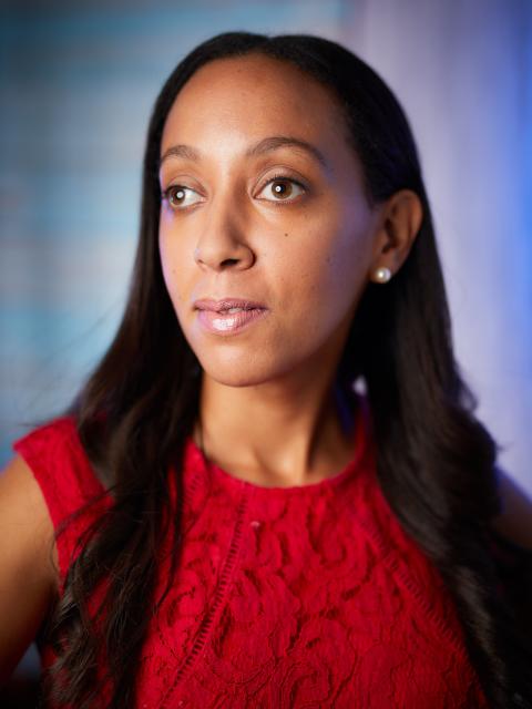 Haben Girma, a Black woman in her thirties wearing a thoughtful expression