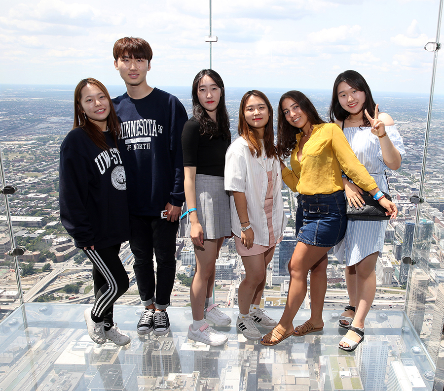 A group of students attending UW-Stout this summer stand on the observation ledge atop Willis Tower, formerly Sears Tower, during a university-guided trip to Chicago. 