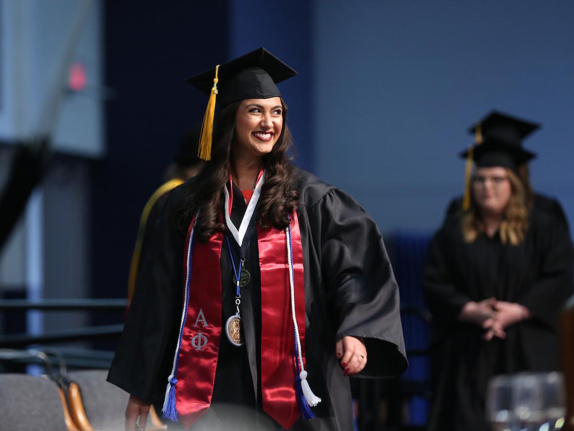 Asha Bahr, rehabilitation services graduate, crossing the stage at commencement, May 2018.