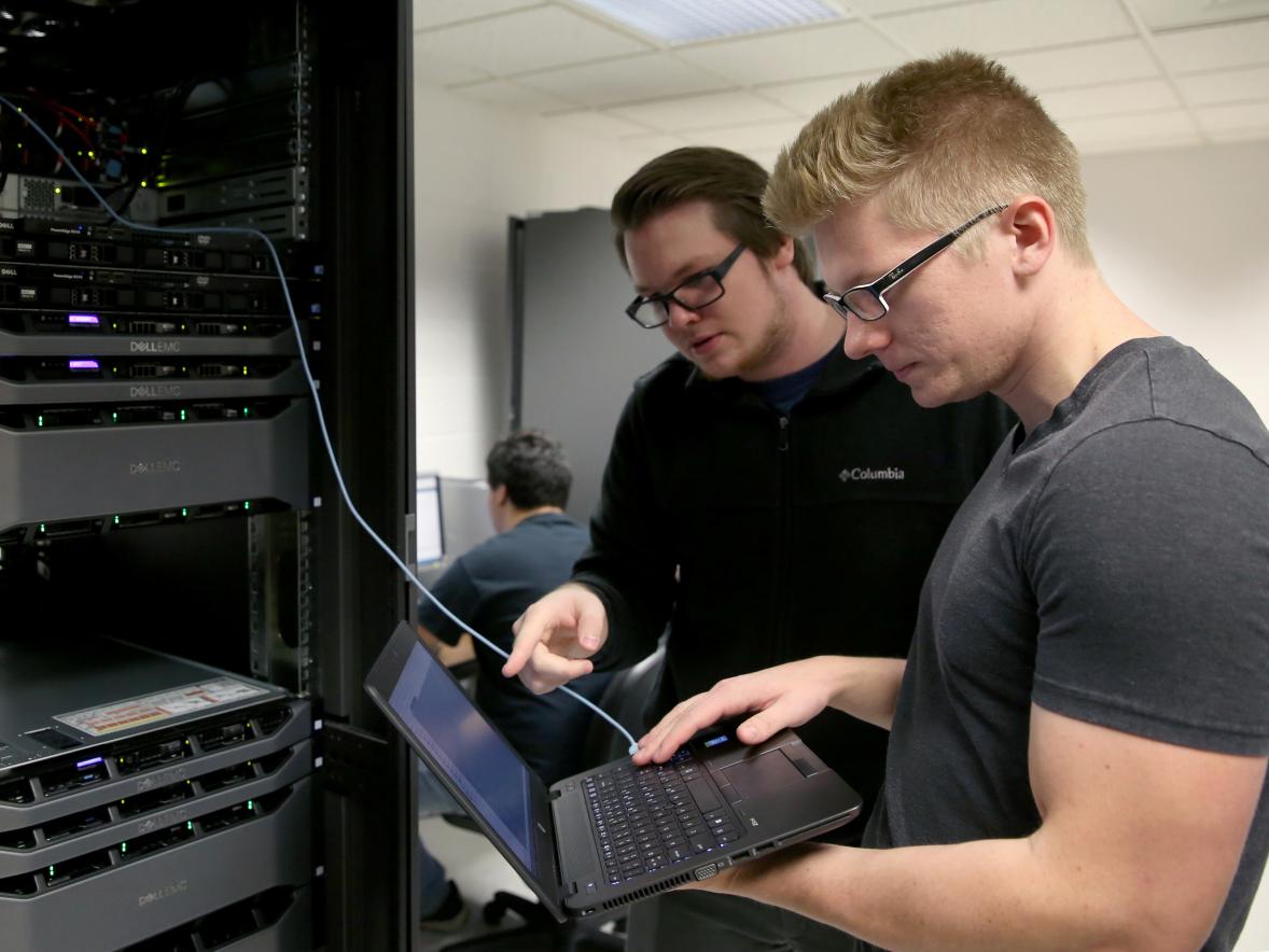 Students at UW-Stout tackle a problem in a computer networking lab. 
