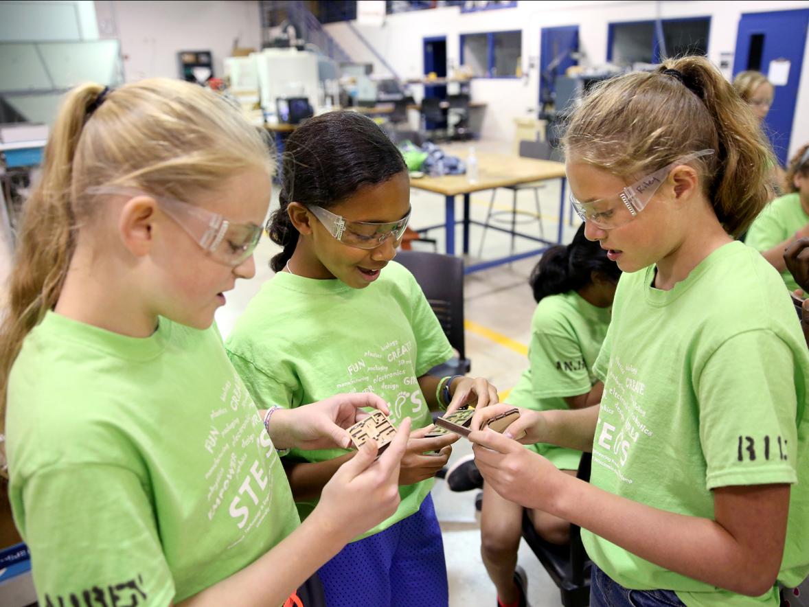 Students in a summer camp look over a project in UW-Stout’s Fab Lab. 