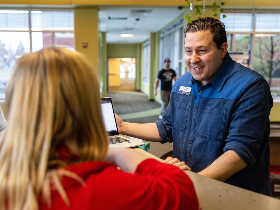 Ian Foley helps students at one of the UW-Stout residence halls.