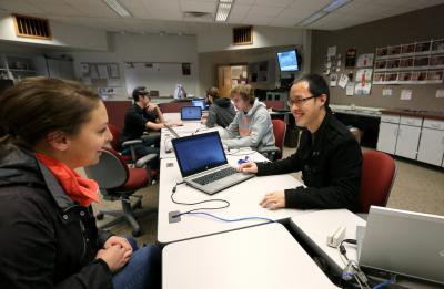 Staff helping a student at the Technology Help Desk in Millennium Hall.