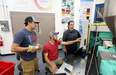 A lab section of Professor Adam Kramschuster's Injection Molding Theory, Design and Application class in the Plastics Engineering lab in Jarvis Hall Tech Wing.